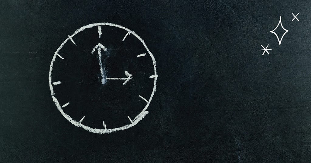 A chalk-drawn clock with simple hour and minute hands displayed on a dark chalkboard background, accompanied by small star-like sparkles in the top right corner, symbolizing time management and clarity to design your budget