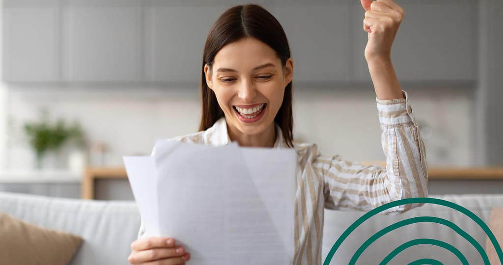 Smiling woman holding financial documents and celebrating success, symbolizing improved credit score from a credit builder loan