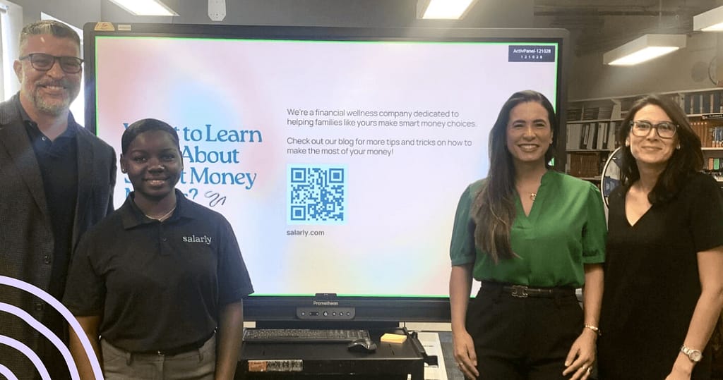 Salarly team with staff at Young Women’s Preparatory Academy during a financial literacy presentation