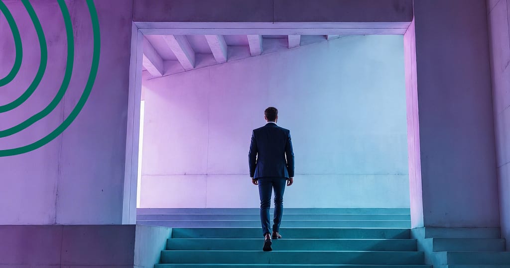 Professional walking up illuminated steps in a modern architectural space symbolizing financial stability and steady progress