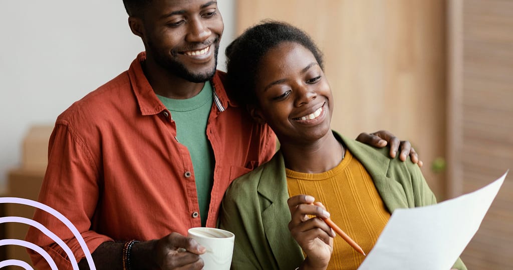 Happy couple celebrating loan approval, representing the ease and success of Salarly's payroll-linked loans