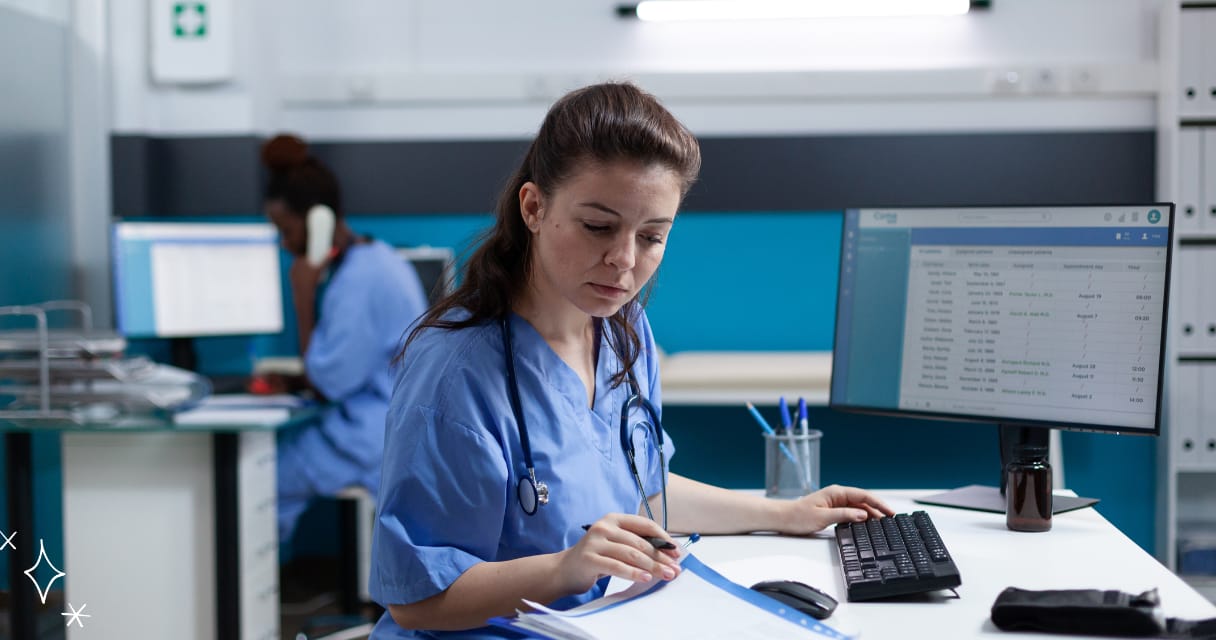 Nurse studying on desk with a computer turned on and white paper to write on her career growth strategies
