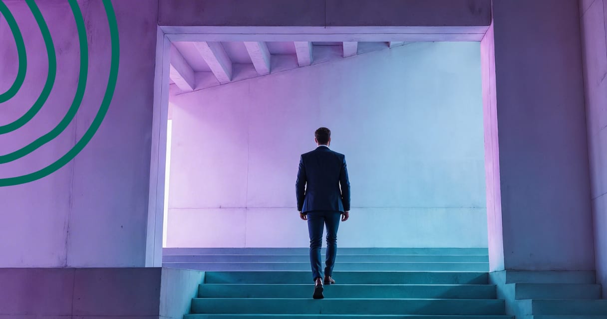 Professional walking up illuminated steps in a modern architectural space symbolizing financial stability and steady progress